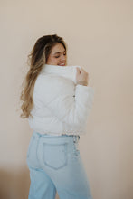 Load image into Gallery viewer, side view of model wearing the time after time puffer in the color ivory. model has the puffer paired with the all along top in the color almond and the camden denim.