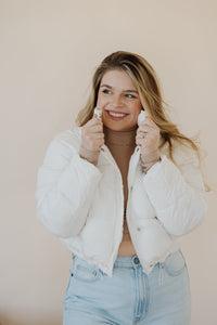 front view of model wearing the time after time puffer in the color ivory. model has the puffer paired with the all along top in the color almond and the camden denim.