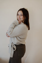 Load image into Gallery viewer, side view of model wearing the when you were mine sweater in the color oatmeal. model has the sweater paired with the Addison denim in the color brown.