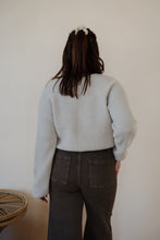 Load image into Gallery viewer, back view of model wearing the Addison denim in the color brown. model has the denim paired with the when you were mine sweater in the color oatmeal.