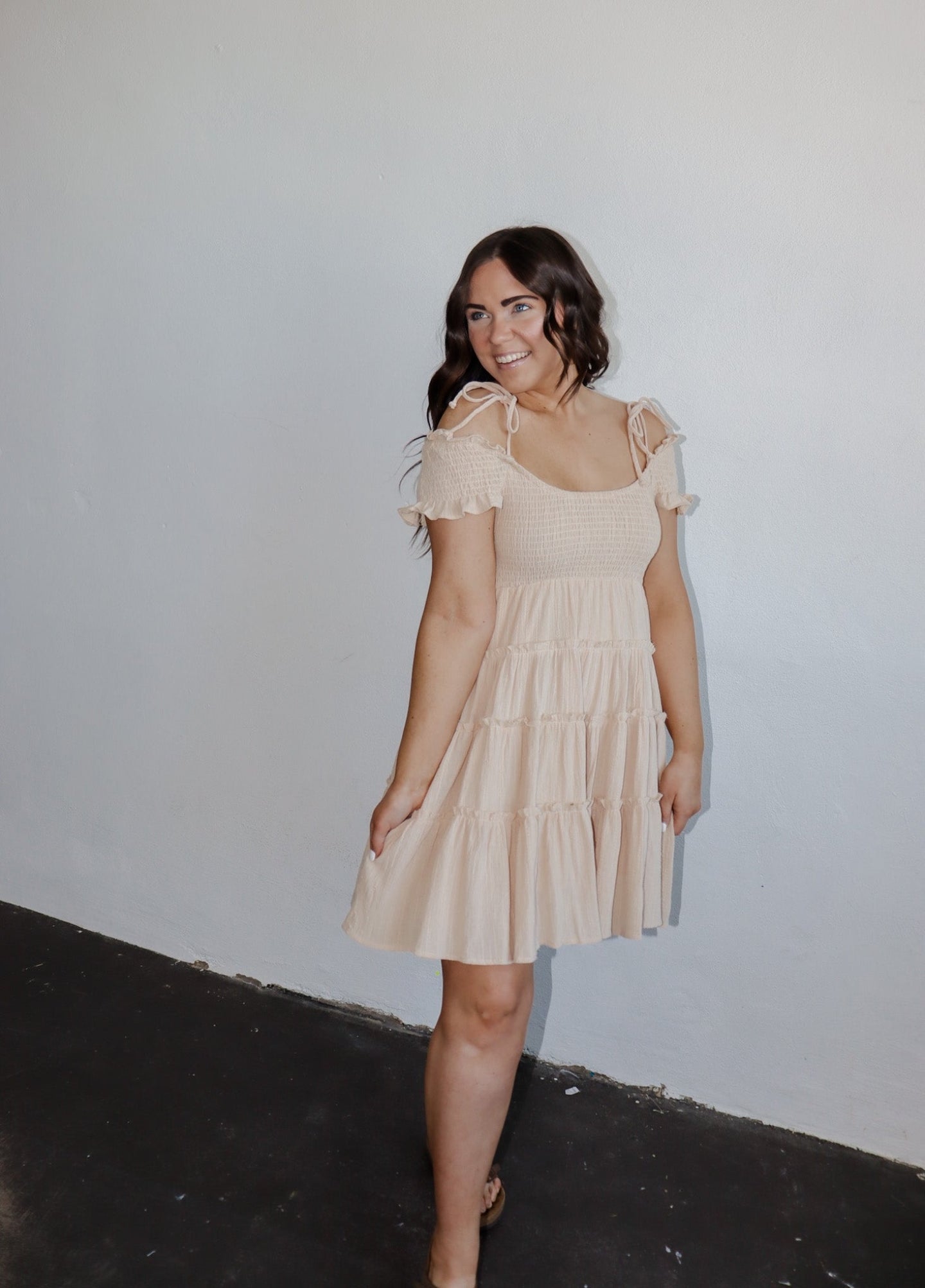 model wearing the drift away mini dress. model has the dress paired with a neutral pair of flatbed sandals.