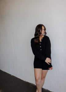 model wearing the before you go knit sweater romper in the color black.