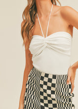 Load image into Gallery viewer, model wearing the think of me top in the color white. model has the top paired with a black and cream checkered skirt.