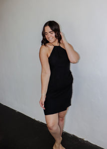 model wearing the keeping score dress in the color black.