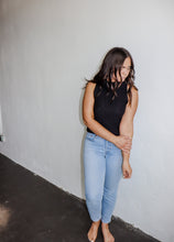 Load image into Gallery viewer, model wearing the simple love top in the color black. model has the top paired with a pair of light wash denim.