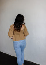 Load image into Gallery viewer, model wearing the everything I need top. model has the top paired with a pair of light wash denim.