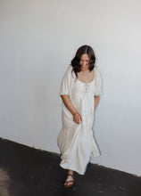 Load image into Gallery viewer, model wearing the low tide maxi dress. model has the dress paired with a pair of neutral flatbed sandals.