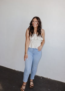 model wearing the by the shore top. model has the top paired with a pair of lightwash denim and neutral flatbed sandals.