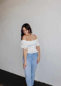 model wearing the wish you the best top. model has the top paired with a pair of light wash denim.
