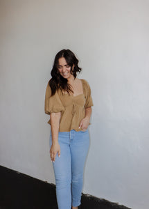 model wearing the everything I need top. model has the top paired with a pair of light wash denim.