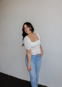 model wearing the wish you the best top. model has the top paired with a pair of light wash denim.