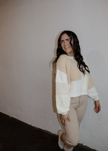 model wearing the finding my way sweater. model has the sweater paired with the siena denim and a pair of platform sneakers.