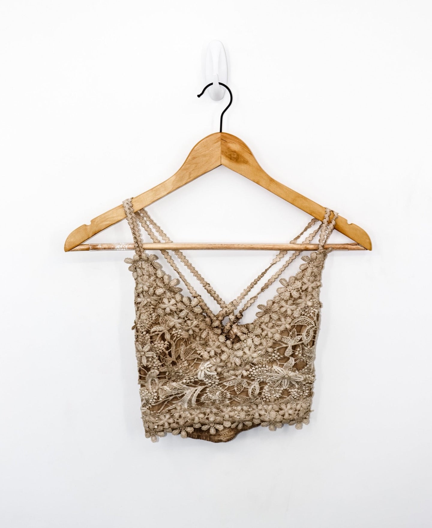 front view of always knew floral lace bralette in the color taupe, pictured on a wooden hanger with a white backdrop