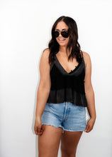 Load image into Gallery viewer, model wearing the moving on top in the color black paired with light denim shorts; model is wearing a pair of sunglasses