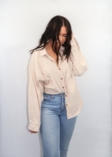Load image into Gallery viewer, model wearing the anywhere but here lightweight corduroy shacket in the color sand. model has paired the top with a pair of light denim and is looking downward.