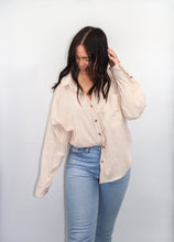 Load image into Gallery viewer, model wearing the anywhere but here lightweight corduroy shacket in the color sand. model has paired the top with a pair of light denim and is smiling and looking downward.
