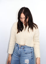 Load image into Gallery viewer, model wearing the how the story goes sweater paired with high-waisted denim jeans