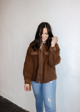Load image into Gallery viewer, model wearing the never look back jacket in the color brown. model has the jacket paired with the can&#39;t get enough top in the color oatmeal and a pair of denim.