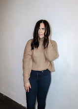 Load image into Gallery viewer, model wearing the patiently waiting sweater in the color oat. model has the sweater paired with a pair of black denim.