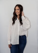 Load image into Gallery viewer, model wearing the play by my rules top in the color white. model has the top paired with a pair of high-waited, dark-wash denim.