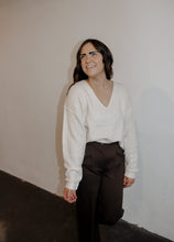 Load image into Gallery viewer, model wearing the play it cool sweater. model has the top paired with the logan trousers in the color espresso and a pair of platform sneakers.