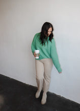 Load image into Gallery viewer, model wearing the patiently waiting sweater in the color jade. model has the sweater paired with the siena denim.