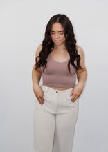 Load image into Gallery viewer, model wearing the stay the same top in the color espresso. model has the top paired with the chelsea linen trousers in the color oatmeal.
