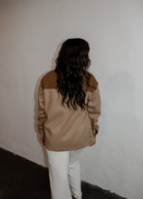 Load image into Gallery viewer, model wearing the never say never jacket in the color camel/taupe. model has the jacket paired with the by your side top in the color taupe and the chelsea linen trousers in the color oatmeal.