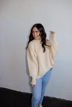 Load image into Gallery viewer, model wearing the eighth avenue tunic sweater in the color ivory. model has the top paired with a pair of lightwash denim.