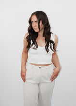 Load image into Gallery viewer, model wearing the stay the same top in the color cream. model has the top paired with the chelsea linen trousers in the color oatmeal.