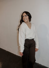 Load image into Gallery viewer, model wearing the play it cool sweater. model has the top paired with the logan trousers in the color espresso and a pair of platform sneakers.