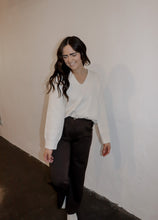 Load image into Gallery viewer, model wearing the a night like this sweater. model has the top paired with the logan trousers in the color espresso and a pair of platform sneakers.