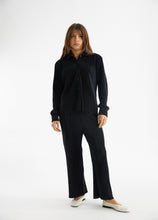 Load image into Gallery viewer, model wearing the aspen top + aspen pants in the color black.